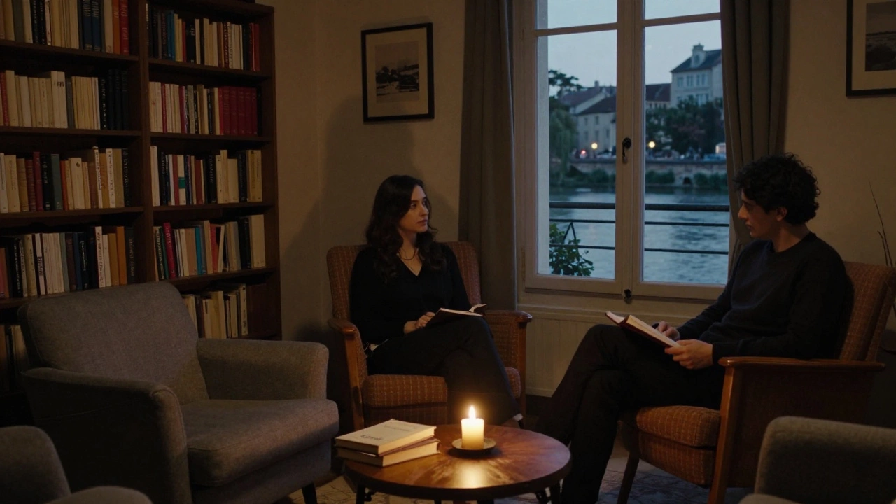 Two people sit in quiet companionship in a cozy Avignon apartment filled with books and soft candlelight.